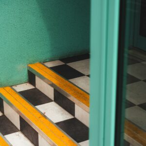 Metal edge trim fitted to a stair nosing