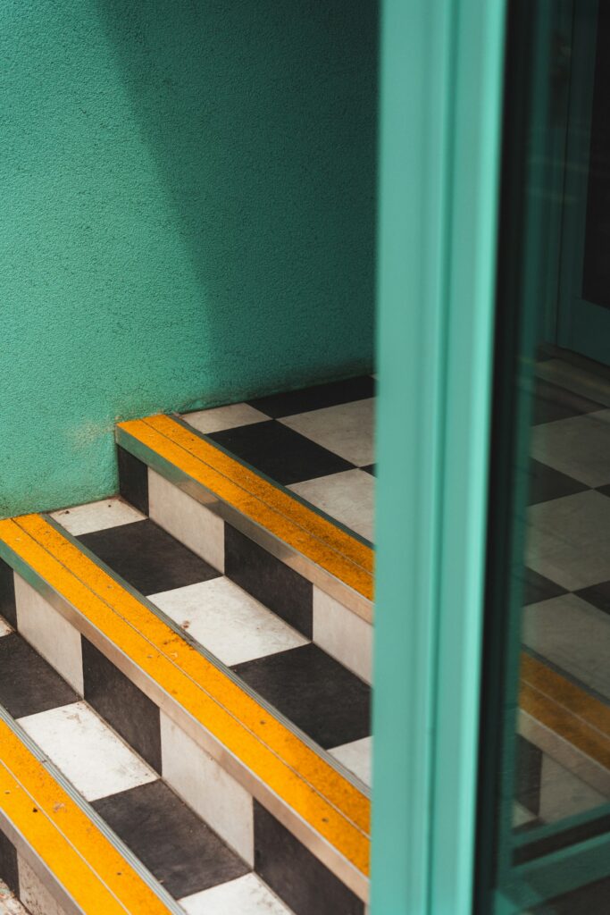 Metal edge trim fitted to a stair nosing